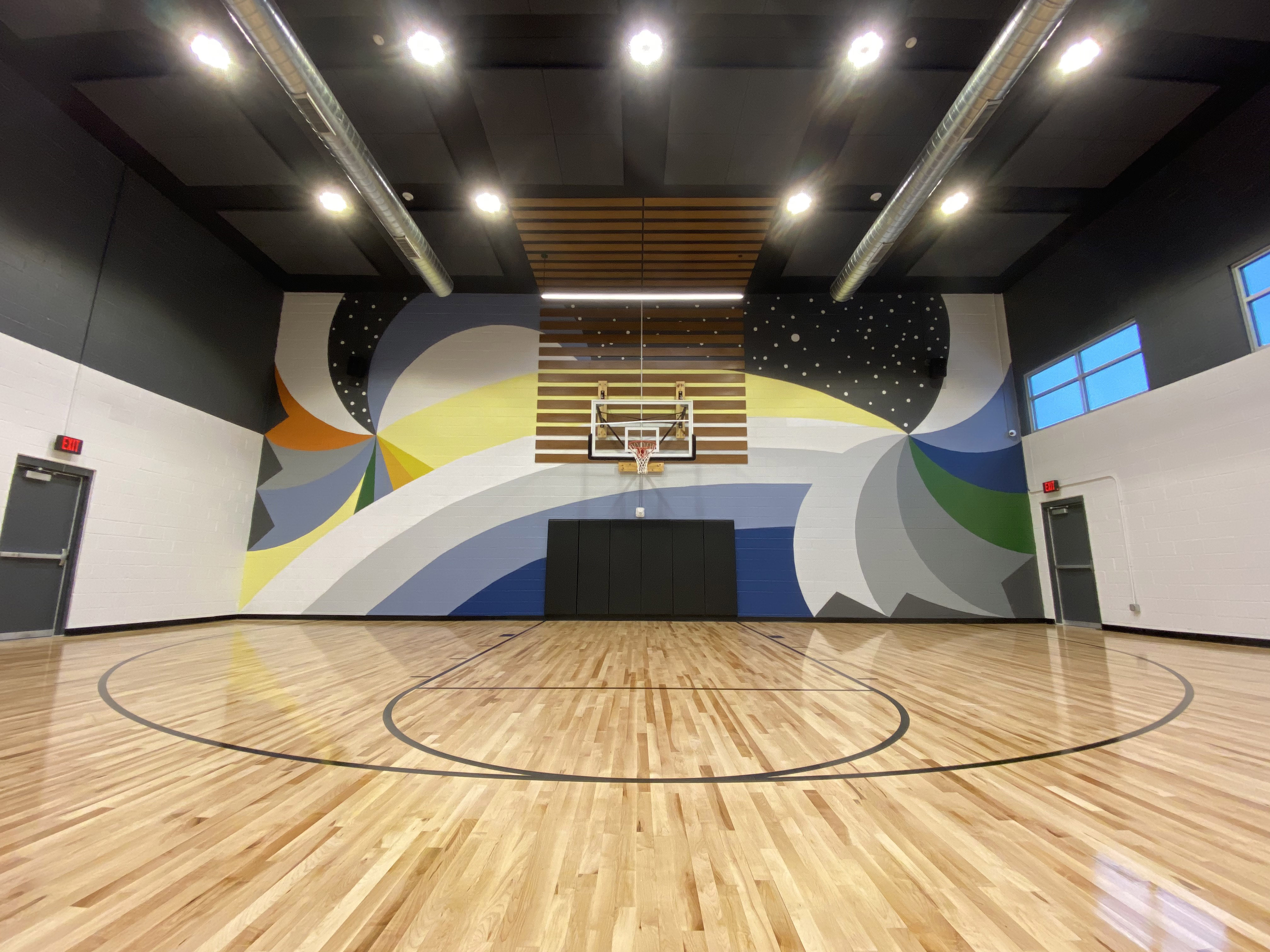 head-on view of entire mural from the three point line of the basketball court